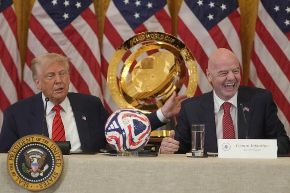 President Donald Trump and FIFA President Gianni Infantino talk during a FIFA task force meeting in the East Room of the White House, Tuesday, May 6, 2025, in Washington. (AP Photo/Mark Schiefelbein)
 ...