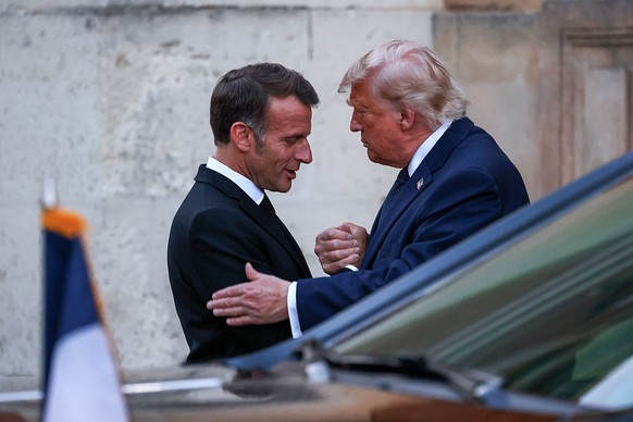 VERSAILLES, FRANCE - JUNE 17: President of France, Emmanuel Macron and U.S. President Donald Trump shake hands upon their arrival at Chateau de Versailles as French President Emmanuel Macron hosts a d ...
