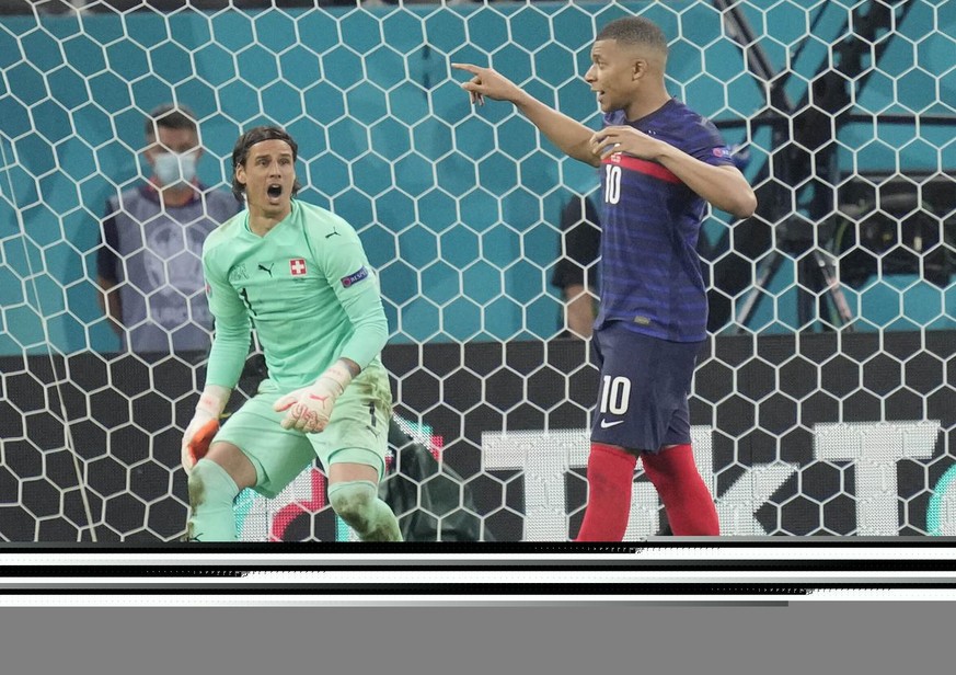 Switzerland's goalkeeper Yann Sommer reacts after France's Kylian Mbappe failed to score by penalty at the Euro 2020 soccer championship round of 16 match between France and Switzerland at the Nationa ...