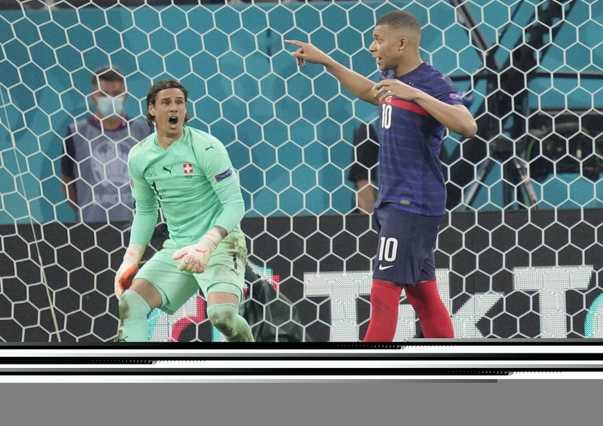 Switzerland&#039;s goalkeeper Yann Sommer reacts after France&#039;s Kylian Mbappe failed to score by penalty at the Euro 2020 soccer championship round of 16 match between France and Switzerland at t ...