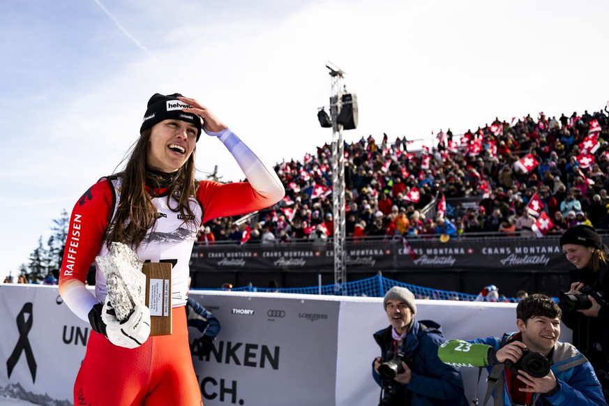 The winner Malorie Blanc of Switzerland celebrates with the trophy after the podium ceremony of the women's Super-G race at the Alpine Skiing FIS Ski World Cup, in Crans-Montana, Switzerland, Sat ...