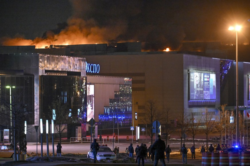 A massive blaze is seen over the Crocus City Hall on the western edge of Moscow, Russia, Friday, March 22, 2024. Several gunmen have burst into a big concert hall in Moscow and fired automatic weapons ...
