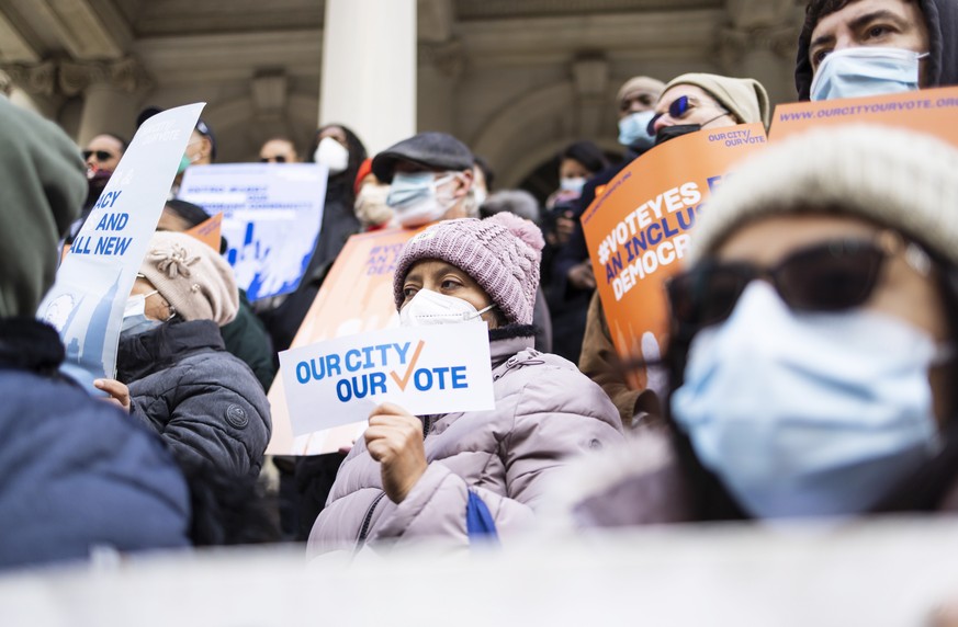 epa09632236 Supporters of a New York City Council bill that allow noncitizens to vote gather for a rally on the steps of New York City Hall in New York, New York, USA, 09 December 2021. The legislatio ...