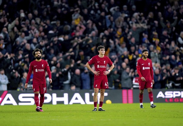 Liverpool&#039;s Mohamad Salah, Stefan Bajcetic and Joe Gomez look on after Wolverhampton Wanderers&#039; Ruben Neves scores his side&#039;s third goal of the game, during the English Premier League s ...