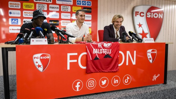 Mario Balotelli of Italy and new FC Sion soccer player, left, speaks next to Baptiste Coppey, center, communication manager and Barthelemy Constantin, right, sport director of FC Sion, during a press  ...