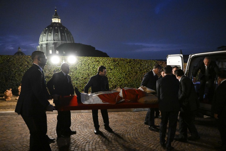 In this image released on Monday, Jan. 2, 2023, by the Vatican Media news service, the body of late Pope Emeritus Benedict XVI is carried from the chapel of the monastery 'Mater Ecclesiae' a ...
