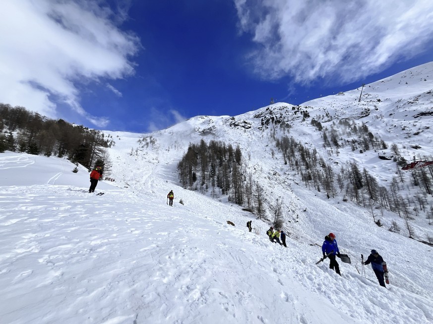 In this handout photo provided by Kantonspolizei Wallis via Keystone, Rescuers work on a site of an avalanche fell on the Riffelberg, Switzerland, Tuesday, April 2, 2024. An American teenager and two  ...