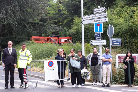 epa10720821 People wait next to the entrance of Mont Valerien cemetery, where Nahel Merzouk will be laid to rest, in Nanterre, near Paris, France, 01 July 2023. Nahel Merzouk will be buried in Mont Va ...