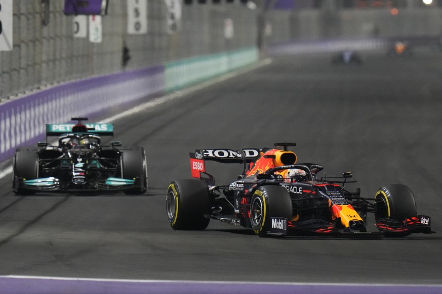 Red Bull driver Max Verstappen of the Netherlands, front, and Mercedes driver Lewis Hamilton of Britain in action t during the Formula One Saudi Arabian Grand Prix in Jiddah, Sunday, Dec. 5, 2021. (AP ...