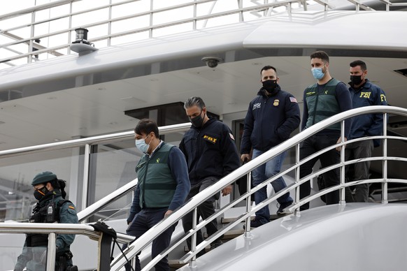 Civil Guards accompany U.S. FBI agents and a U.S.Homeland Security agent from the yacht called Tango in Palma de Mallorca, Spain, Monday April 4, 2022. U.S. federal agents and Spain&#039;s Civil Guard ...