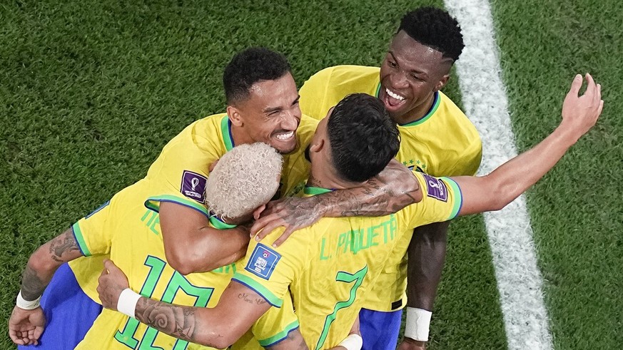 Teammates celebrate with Brazil's Lucas Paqueta who scored his side's fourth goal during the World Cup round of 16 soccer match between Brazil and South Korea, at the Education City Stadium in Al Rayy ...