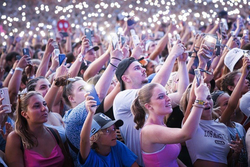 Festival goers cheer as French rapper Ninho performs on the main stage during the 45th edition of the Paleo Festival, in Nyon, Switzerland, Saturday, July 23, 2022. The Paleo is the largest open-air m ...