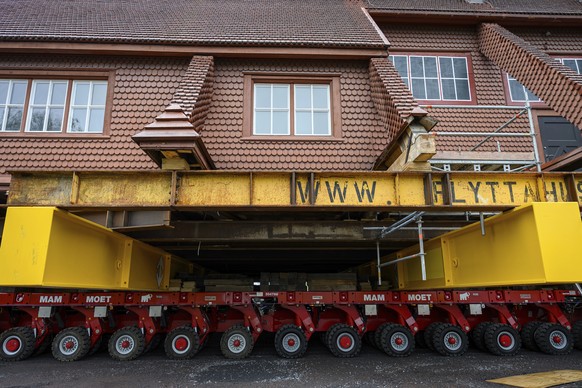 Beams placed on an wheeled structure support the Kiruna Church, a Sami style wooden Swedish Lutheran church, called Kiruna Kyrka in Swedish, in Kiruna, Sweden, Monday, Aug. 18, 2025, a day before it w ...
