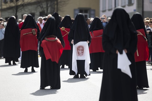 epa12039236 Women dressed in black veils and known as Les Pleureuses (the weepers) walk around the Collegiale de Notre-Dame de l&#039;Assomption carrying wips, a thorn crown, nails and a shroud during ...