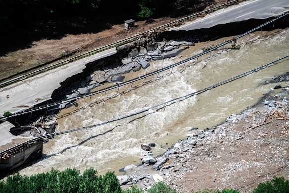 epa11430293 A picture taken with a drone of the area affected by a landslide with a damaged street, caused by the bad weather and heavy rain in the Misox valley, in Lostallo, southern Switzerland, 22  ...