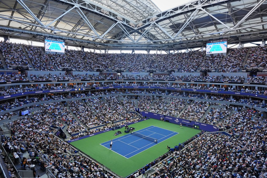 Alexander Zverev, of Germany, left, serves to Ben Shelton, of the United States, during the men's singles final of the U.S. Open tennis championships Sunday, Sept. 13, 2026, in New York. (AP Phot ...