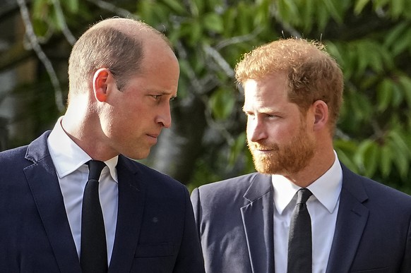 Britain&#039;s Prince William and Britain&#039;s Prince Harry walk beside each other after viewing the floral tributes for the late Queen Elizabeth II outside Windsor Castle, in Windsor, England, Satu ...