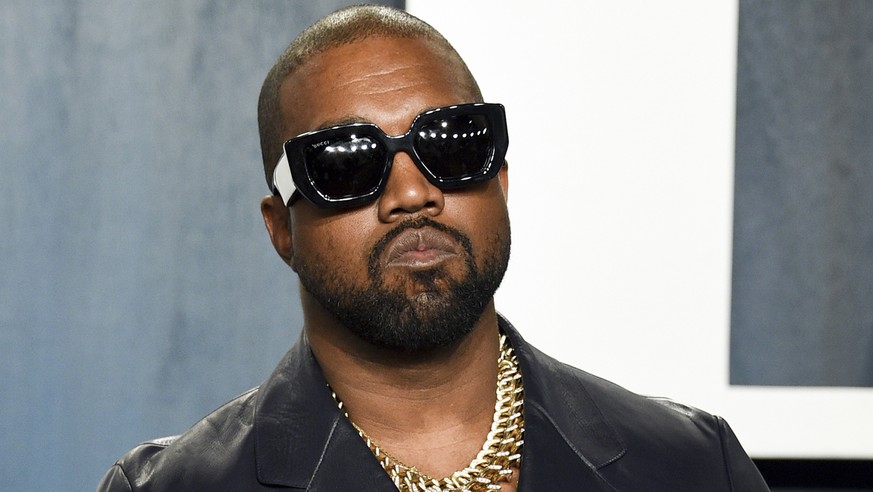 FILE - Kanye West appears at the Vanity Fair Oscar Party in Beverly Hills, Calif., on Feb. 9, 2020. Police say they are investigating after a battery report was filed Thursday, Jan. 13, 2022, against  ...
