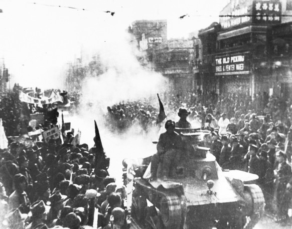 In this May 2, 1949, file photo, a column of Chinese Communist light tanks enter the streets of Beijing, formerly known as Peking, which are filled with people watching the conquerors pass. In 1949, C ...