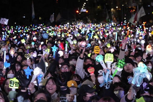 Participants gather to celebrate after South Korea&#039;s parliament voted to impeach President Yoon Suk Yeol outside the National Assembly in Seoul, South Korea, Saturday, Dec. 14, 2024. (AP Photo/Ah ...