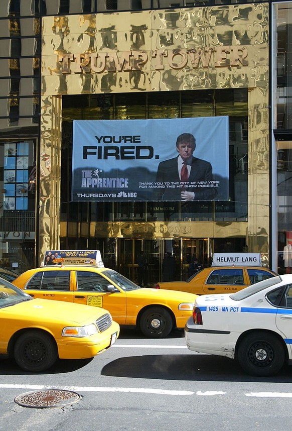 Banner advertisement for "The Apprentice" hanging outside of Trump Tower has been deemed a violation of zoning laws and must be removed (Photo by Gregory Pace/FilmMagic)