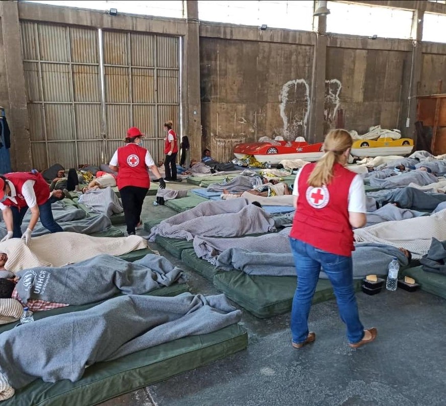 epa10692188 A handout photo made available by the Hellenic Red Cross shows the warehouse where refugees and migrants are treated following a deadly shipwreck off Pylos, in the port of Kalamata, Greece ...