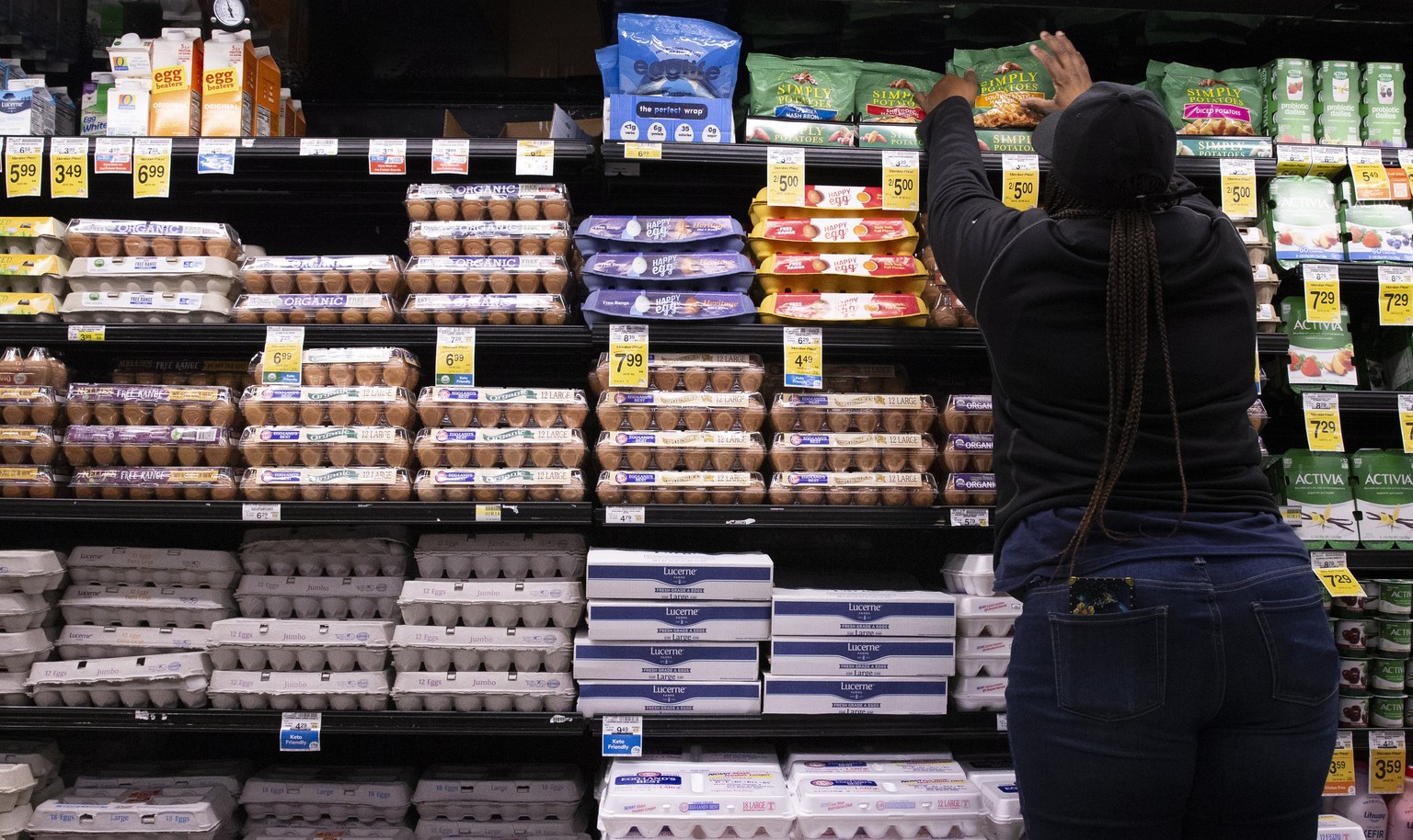 epa10270129 An employee stocks food items beside eggs at a Safeway supermarket, a subsidiary of Albertsons, in Washington, DC, USA, 27 October 2022. DC's Office of the Attorney General will investigat ...