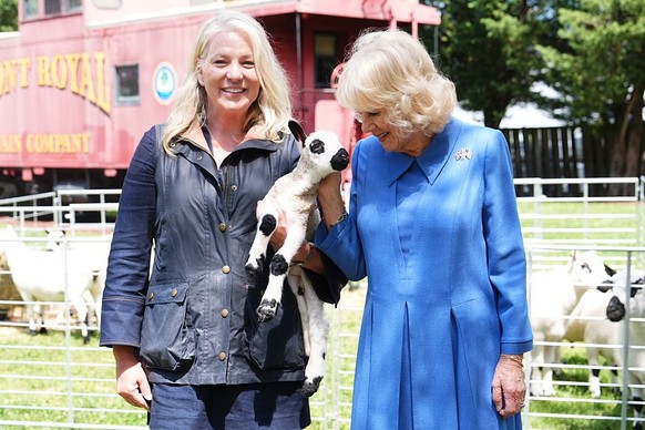 FRONT ROYAL, VIRGINIA - APRIL 30: Queen Camilla (right) meets with community members during a block party and potluck on April 30, 2026 in Front Royal, Virginia. King Charles III and Queen Camilla vis ...