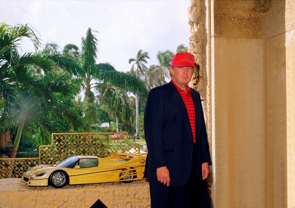 Portrait of American real estate developer Donald Trump as he poses in front of a model of a car at the Mar-a-Lago club, Palm Beach, Florida, January 23, 2000. The model, of a varient of a Ferrari f50 ...