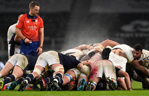 epa08992221 Referee Andrew Brace (L) watches the scrum during the Rugby Six Nations match between England and Scotland in Twickenham, Britain, 06 February 2021. EPA/FACUNDO ARRIZABALAGA