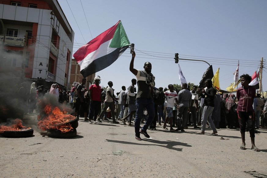 Sudanese demonstrators attend rally to demand the return to civilian rule nearly a year after a military coup led by General Abdel Fattah al-Burhan, in Khartoum, Sudan, Tuesday, Oct. 25, 2022. (AP Pho ...