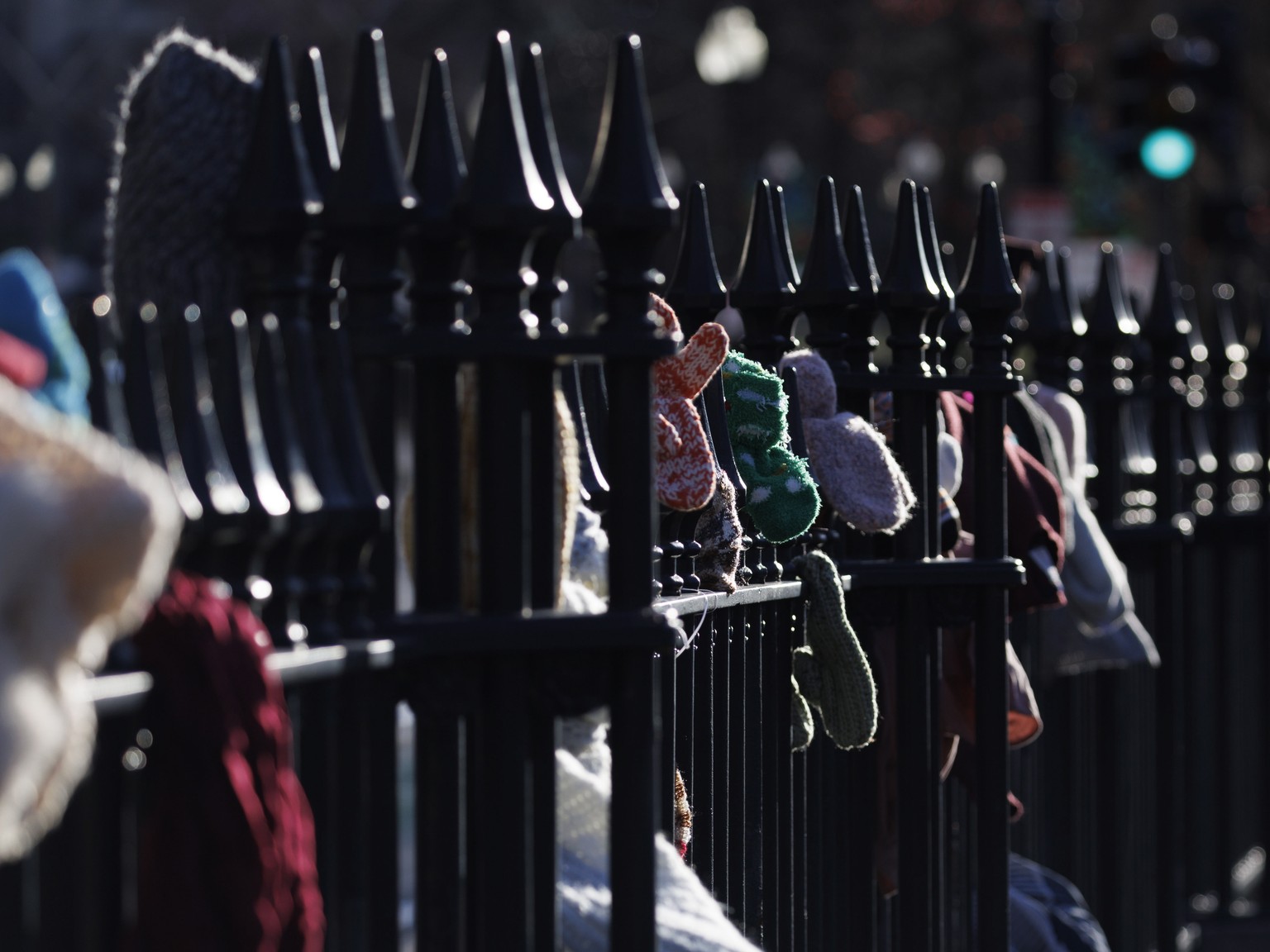 epa10446156 Hats, gloves, mittens, scarfs and bedding left along the fence by donators for anyone who is in need, at the Boston Common in Boston, Massachusetts, USA, 03 February 2023. According to the ...
