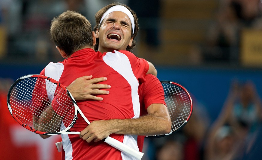 Roger Federer, right, and Stanislas Wawrinka of Switzerland react after their gold medal match against Swedish pair Simon Aspelin and Thomas Johansson at the Beijing Olympic Green Tennis Central Court ...