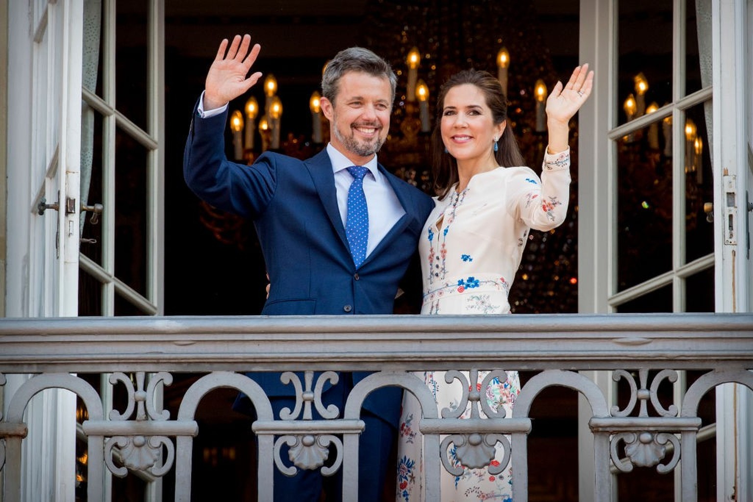 COPENHAGEN, DENMARK - MAY 26: Crown Prince Frederik of Denmark and Crown Princess Mary of Denmark waves as the Royal Life Guards carry out the changing of the guard on Amalienborg Palace square on the ...