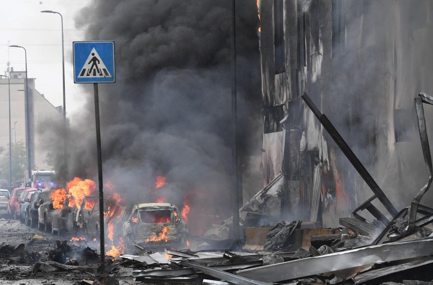 epa09503291 Firefighters work in the building on which a small private plane crashed into the San Donato Milanese district in Milan, Italy, 03 October 2021. A small private plane crashed into a buildi ...