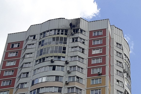 An investigator inspects a damage after a Ukrainian drone attacked an apartment building in Moscow, Russia, Tuesday, May 30, 2023. In Moscow, residents reported hearing explosions and Mayor Sergei Sob ...