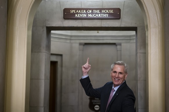 House Speaker Kevin McCarthy of Calif., gestures towards the newly installed nameplate at his office after he was sworn in as speaker of the 118th Congress in Washington, early Saturday, Jan. 7, 2023. ...