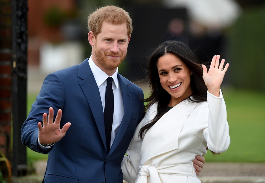 epa09023604 (FILE) - Britain&#039;s Prince Harry pose with Meghan Markle during a photocall after announcing their engagement in the Sunken Garden in Kensington Palace in London, Britain, 27 November  ...