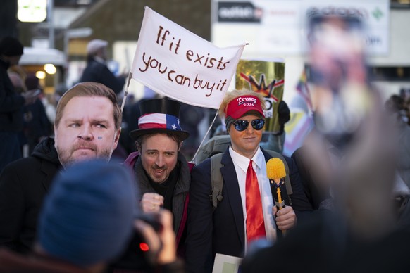 Protesters attend a demonstration prior the 56th annual meeting of the World Economic Forum, WEF, in Davos, Switzerland, Sunday, January 18, 2026. The meeting under the topic "A Spirit of Dialogu ...