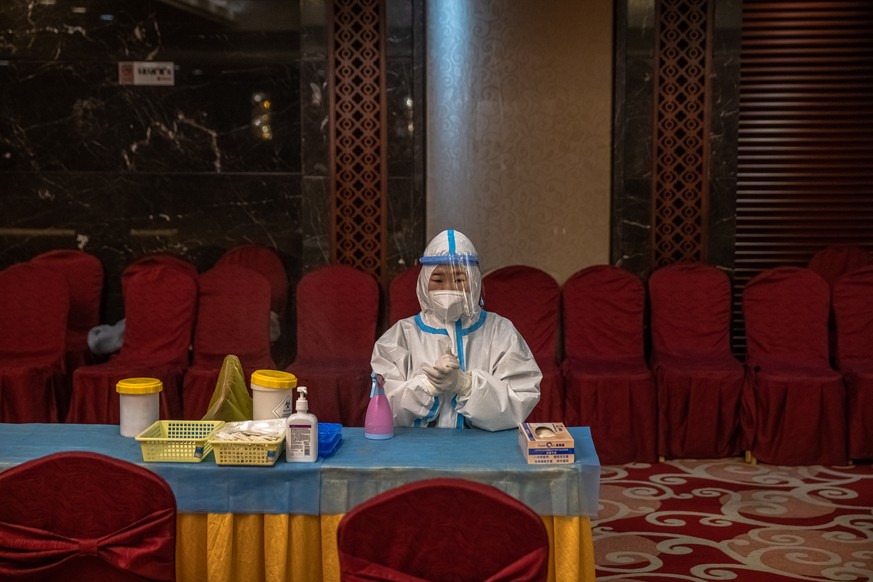 epa09050323 A medical worker waits to carry out COVID-19 tests ahead of the the opening session of the Chinese People&#039;s Political Consultative Conference (CPPCC), in a hotel, in Beijing, China, 0 ...