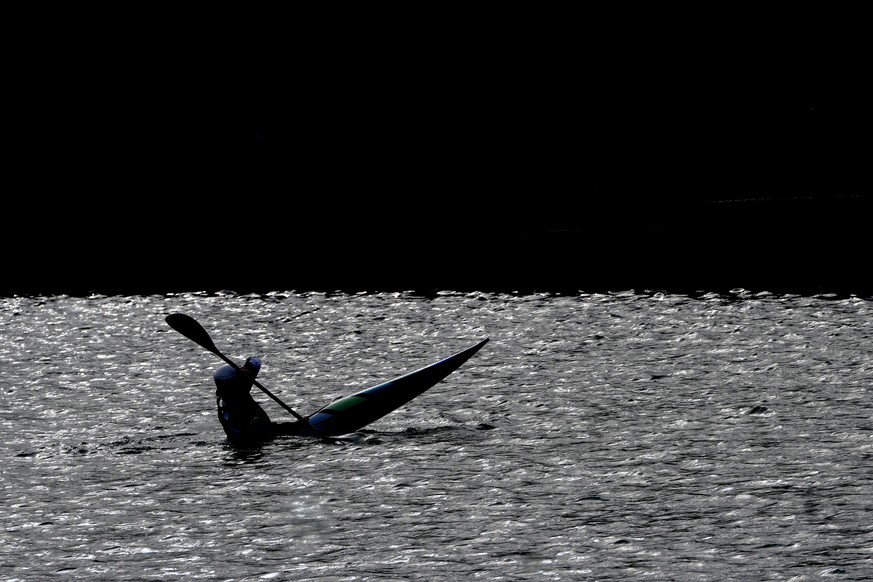 A kayaker is silhouetted at Lee Valley Whitewater Centre in London, Wednesday, April 24, 2024. Great Britain's best canoe slalom athletes are set to embark on the 2024 international season which ...