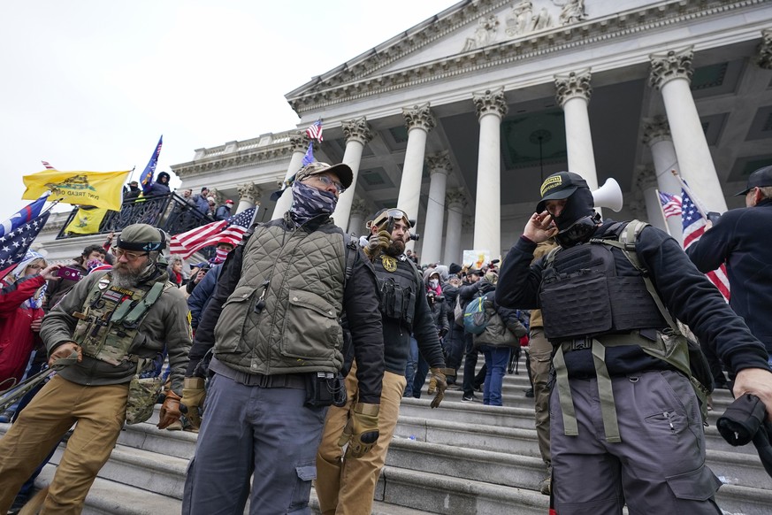 FILE - Members of the Oath Keepers stand on the East Front of the U.S. Capitol on Jan. 6, 2021, in Washington. Federal prosecutors on Monday, Oct. 3, will lay out their case against the founder of the ...