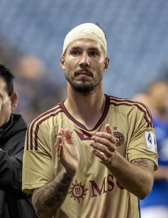 epa10792481 Servette&#039;s Steve Rouiller reacts to the fans at the end of the match, the UEFA Champions League 3rd qualifying round, 1st leg match between Glasgow Rangers and Servette in Glasgow, 09 ...