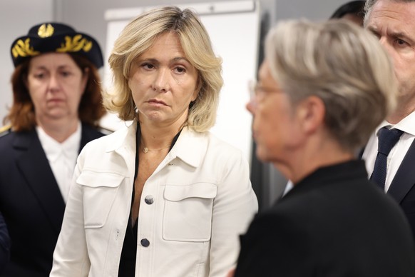 epa10722329 Ile-de-France Region President Valerie Pecresse (2-L) looks on next to Val-de-Marne Prefect Sophie Thibault (L) as French Prime Minister Elisabeth Borne (3-L) meets with municipal police,  ...