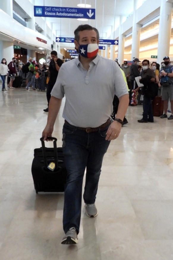 CANCUN, MEXICO - FEBRUARY 18: Sen. Ted Cruz (R-TX) checks in for a flight at Cancun International Airport after a backlash over his Mexican family vacation as his home state of Texas endured a Winter  ...