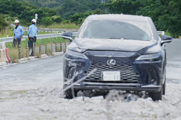 Workers stand near a car damaged in the explosion of nearby AEON Mall, following an earthquake, in Kashima, Kumamoto Prefecture, southern Japan, Wednesday, July 29, 2026. (AP Photo/Hiro Komae)
Japan E ...