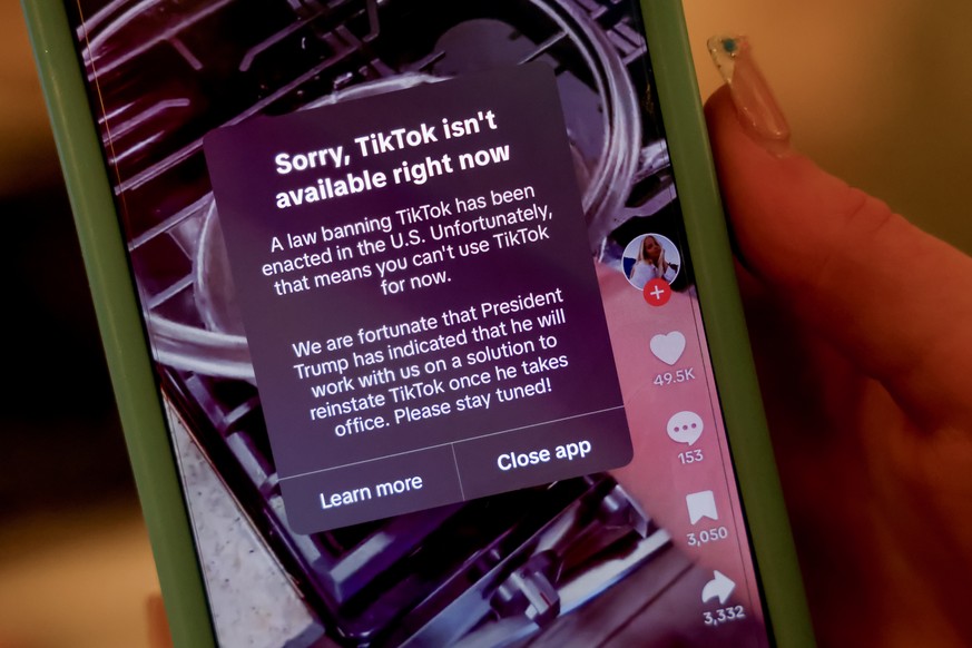 epaselect epa11835228 A person holds an iPhone with a message on their TikTok app in Avondale Estates, Georgia, USA, 18 January 2025. The US Supreme Court has backed a law banning the Chinese-owned Ti ...