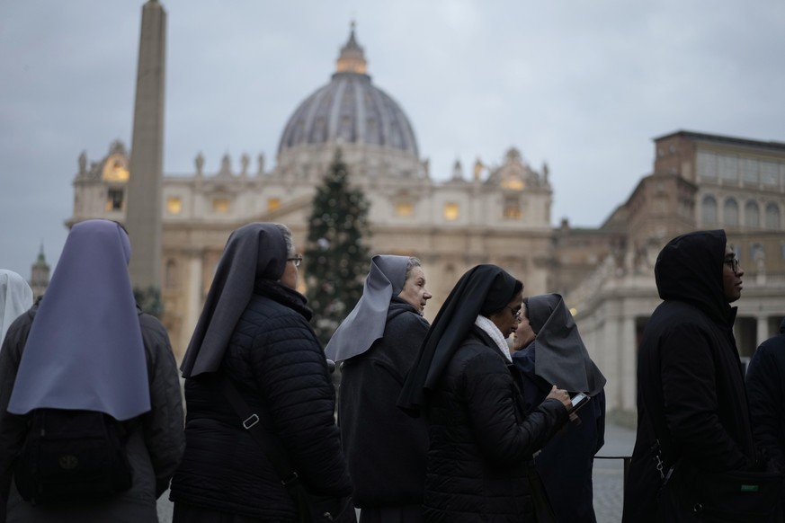 Nuns wait in a line to enter Saint Peter's Basilica at the Vatican where late Pope Benedict 16 is being laid in state at The Vatican, Monday, Jan. 2, 2023. Benedict XVI, the German theologian who ...
