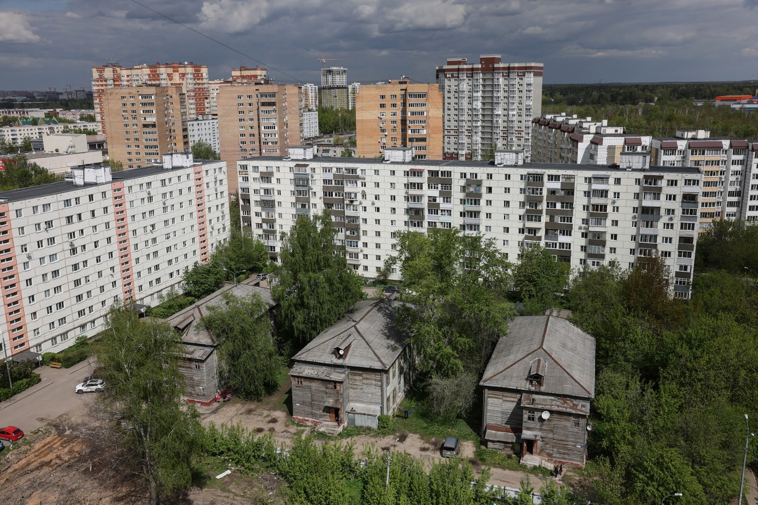 A view shows two-storey wooden communal apartments buildings, which were built for workers in 1906 during the reign of Tsar Nicholas II, in the center of the town of Ivanteyevka on May 7, 2025. (Photo ...