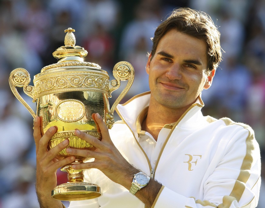 FILE - Roger Federer of Switzerland holds the trophy after defeating Andy Roddick to win the men&#039;s singles championship on the Centre Court at Wimbledon, Sunday, July 5, 2009. Federer announced T ...